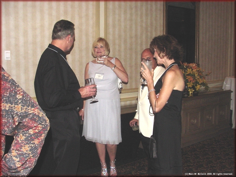 Monty Roberts and Carol Speckman visit with Camille and Bradley Rife on Saturday night