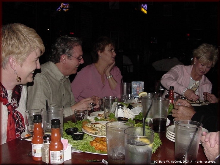 Brenda Babb, Jerry Babb and Jan Sandlin watch Pam Hare Bazet help eat Walt's birthday cake