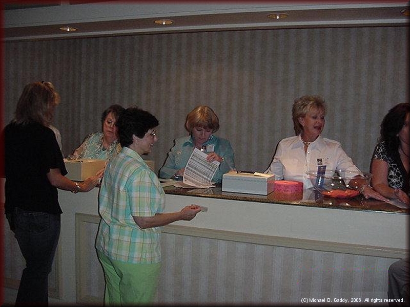 The registration desk was the center of activity before the Friday night party